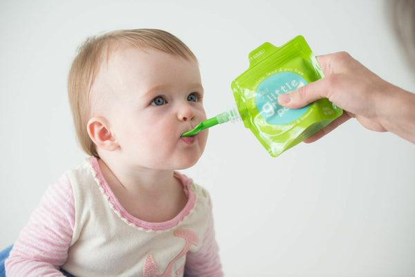 Attach the clip-on dispensing spoon to the Really Littel Green Pouch reusable food pouch for mess-free eating anywhere